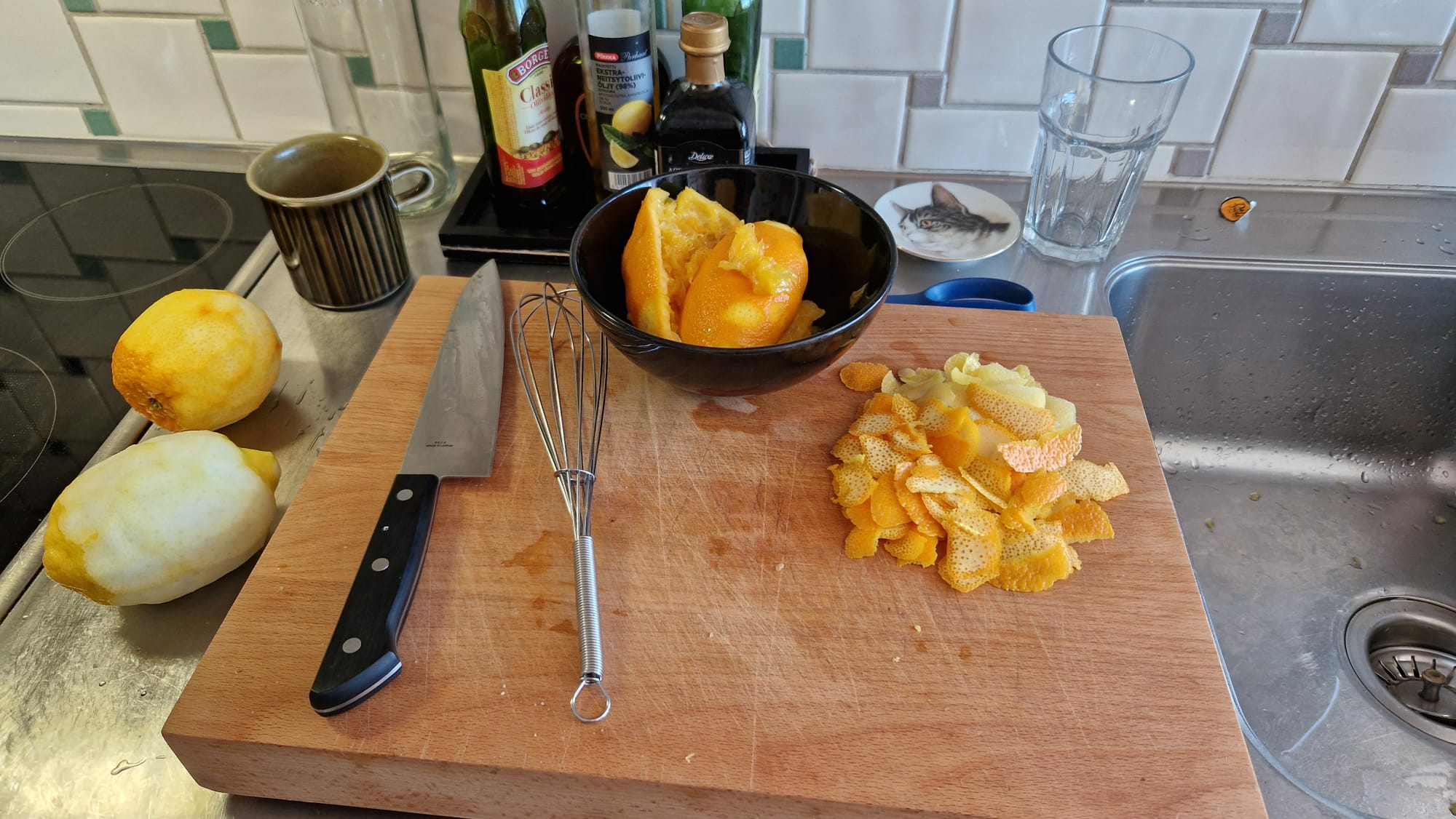Cutting board with citrus fruits and cooking utensils