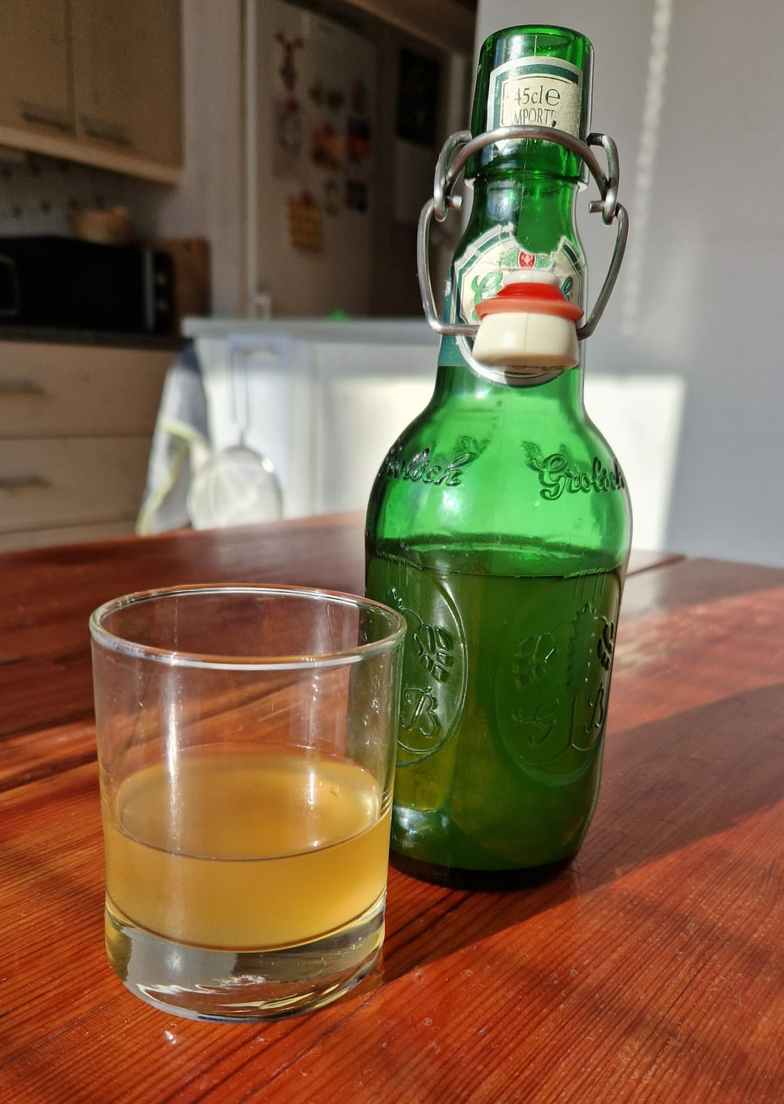 sima bottle and glass sitting on a table